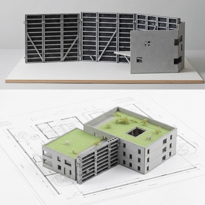 Architect's blueprint and building model with aluminum formwork components, illustrating sustainable design and construction, no text, no words, no typography, clean image