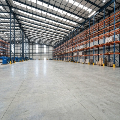 Industrial concrete slab in a large warehouse supporting heavy machinery